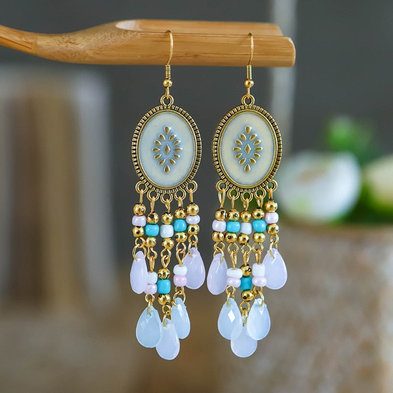 These Bohema Ethnic Fringed Tassel Earrings boast a stylish geometric shape and are crafted with a glossy acrylic water drop. Women of all ages will love wearing these beautiful metal earrings.