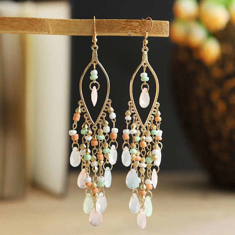 These Bohema Ethnic Fringed Tassel Earrings boast a stylish geometric shape and are crafted with a glossy acrylic water drop. Women of all ages will love wearing these beautiful metal earrings.
