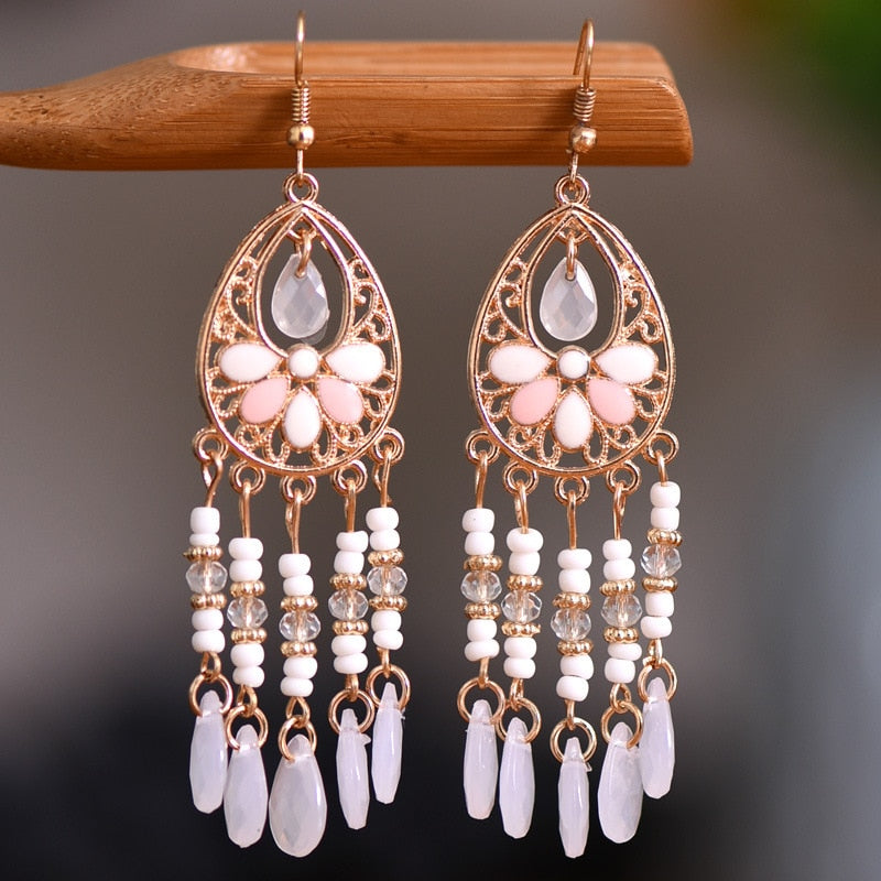 These Bohema Ethnic Fringed Tassel Earrings boast a stylish geometric shape and are crafted with a glossy acrylic water drop. Women of all ages will love wearing these beautiful metal earrings.