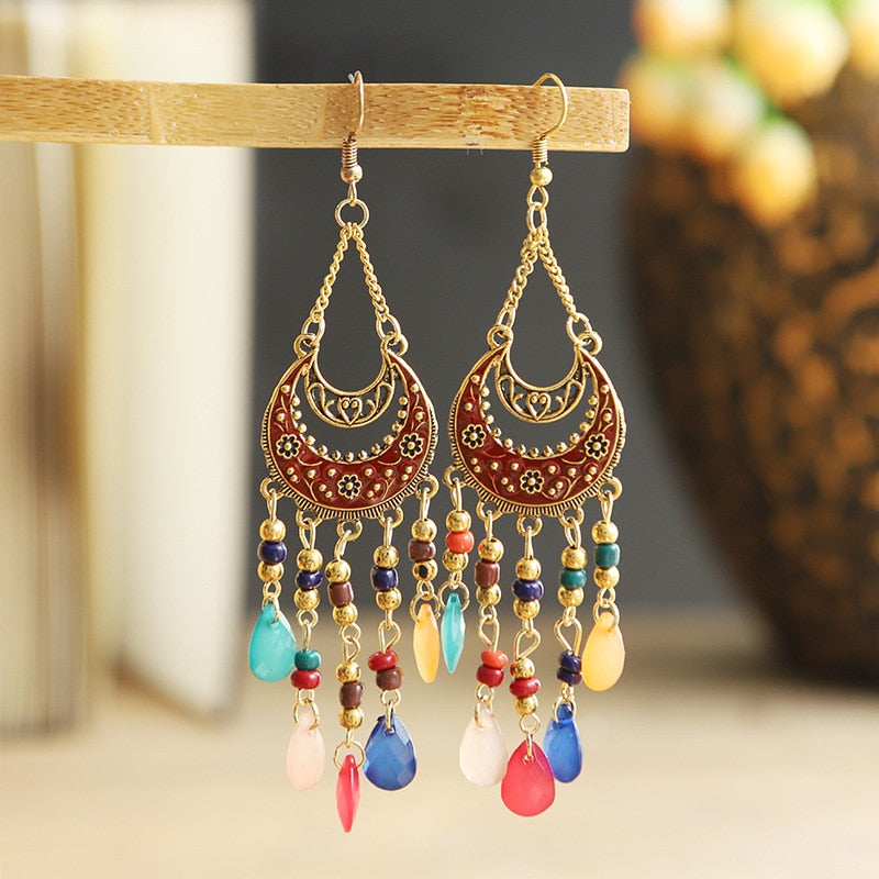 These Bohema Ethnic Fringed Tassel Earrings boast a stylish geometric shape and are crafted with a glossy acrylic water drop. Women of all ages will love wearing these beautiful metal earrings.