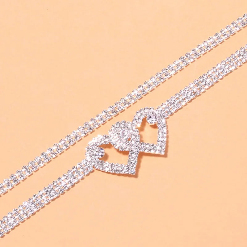 Enhance your style with this stunning silver ankle bracelet adorned with dazzling cubic zirconia stones. This fashionable chain anklet is the perfect accessory to showcase your elegance and add a touch of glamour to your feet.