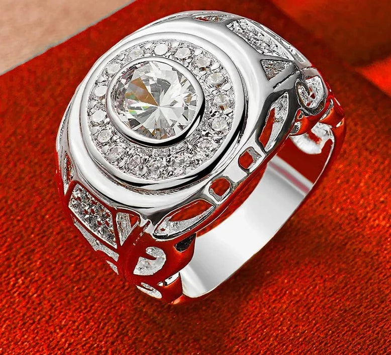 Our exquisite collection of 925 Sterling Silver rings, available in sizes 6-10 for both women and men. Adorned with a captivating large zircon stone, these rings are perfect for fashion-forward individuals looking to make a statement. Whether it's for a wedding, engagement, or any special occasion, our fine jewelry pieces are designed to add charm and elegance to your party ensemble.