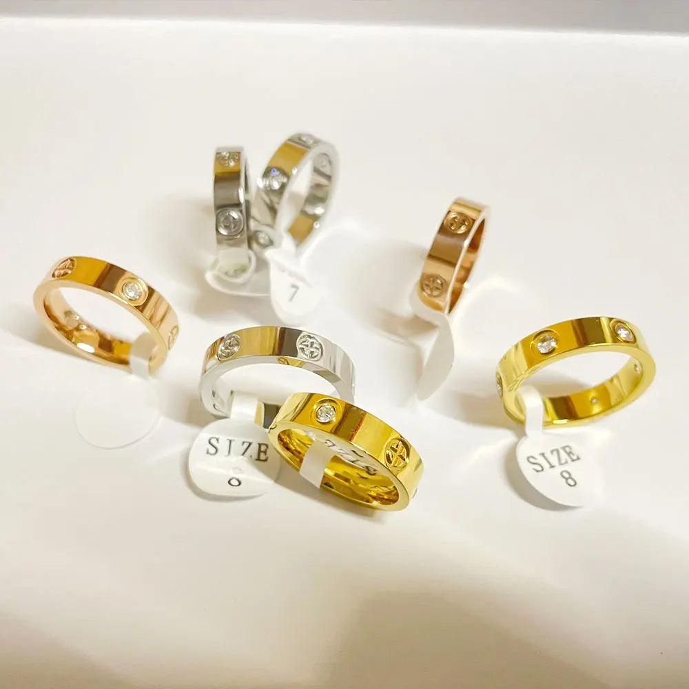 This luxurious piece of jewelry is a stainless steel love ring designed for both men and women. With its classic cross design and rose gold color, it exudes elegance and sophistication. Adorned with CZ crystals, it adds a touch of sparkle and glamour. Perfect as a wedding gift or a symbol of love, this ring is a true statement piece.