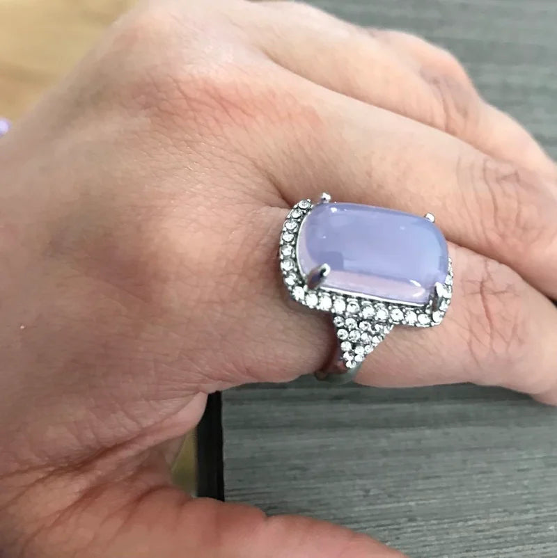 The elegance of our exquisite silver-colored engagement and wedding rings for women, adorned with luxury rectangle light purple zircon stones. This fashion jewelry is designed to add a touch of sophistication to any outfit.