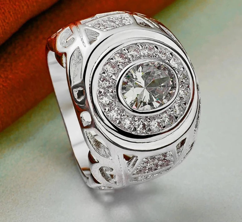 Our exquisite collection of 925 Sterling Silver rings, available in sizes 6-10 for both women and men. Adorned with a captivating large zircon stone, these rings are perfect for fashion-forward individuals looking to make a statement. Whether it's for a wedding, engagement, or any special occasion, our fine jewelry pieces are designed to add charm and elegance to your party ensemble.