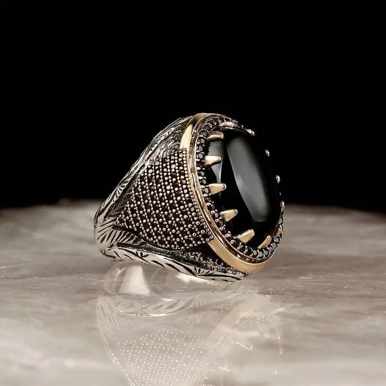 The epitome of elegance with this exquisite men's ring. Crafted from high-quality metal, it features a captivating gold color and is adorned with a striking black stone and zircon accents. Perfect for engagements, weddings, or simply adding a touch of luxury to your everyday style, this punk-inspired ring is a must-have in any fashion-forward man's collection.