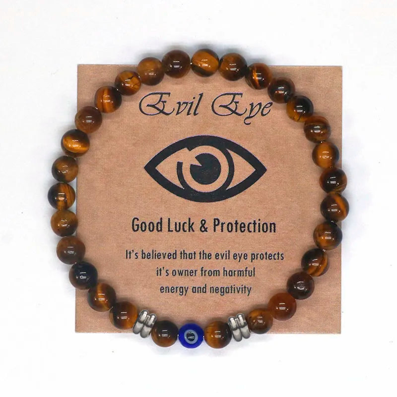 The captivating Tiger Eye Beaded Bracelet, a unisex Turkish Amulet that offers protection against the evil eye. This exquisite piece of spiritual jewelry is designed for both men and women, featuring natural Tiger Eye beads and a striking blue Evil Eye charm.