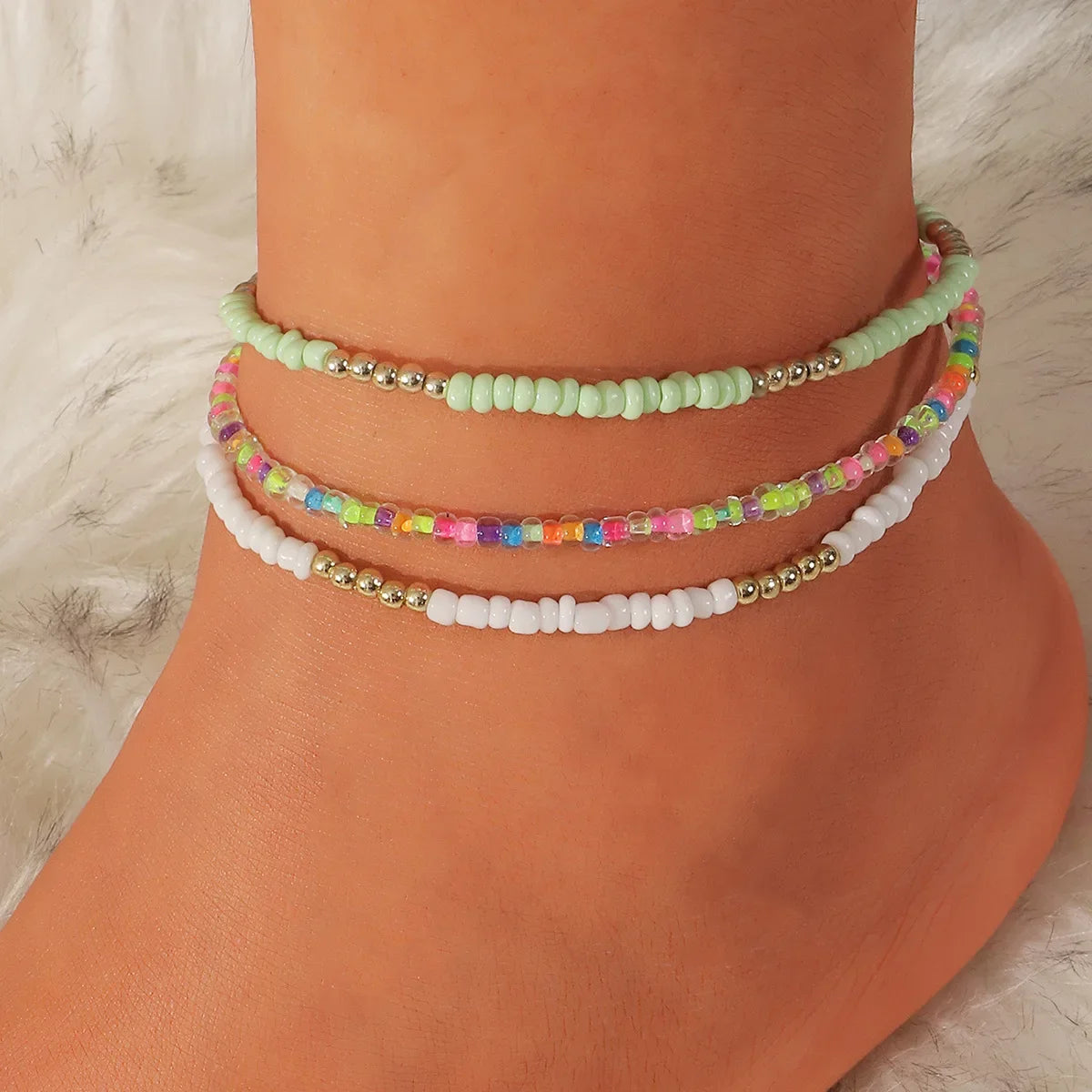 Enhance your summer look with this set of three Bohemian anklets adorned with colorful beaded beads, perfect for a day at the beach or a stroll along the ocean. Handmade with care, these ankle bracelets make a lovely gift for any woman looking to add a touch of boho's chic to her outfit.