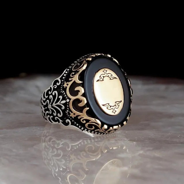 The epitome of elegance with this exquisite men's ring. Crafted from high-quality metal, it features a captivating gold color and is adorned with a striking black stone and zircon accents. Perfect for engagements, weddings, or simply adding a touch of luxury to your everyday style, this punk-inspired ring is a must-have in any fashion-forward man's collection.