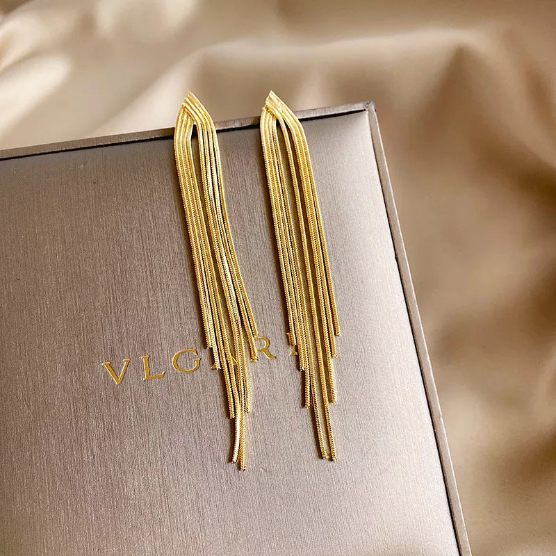 These elegant earrings feature a vintage gold color bar design with long thread tassel drops, perfect for women looking for glossy geometric Korean earrings that are on-trend in new fashion wedding jewelry.