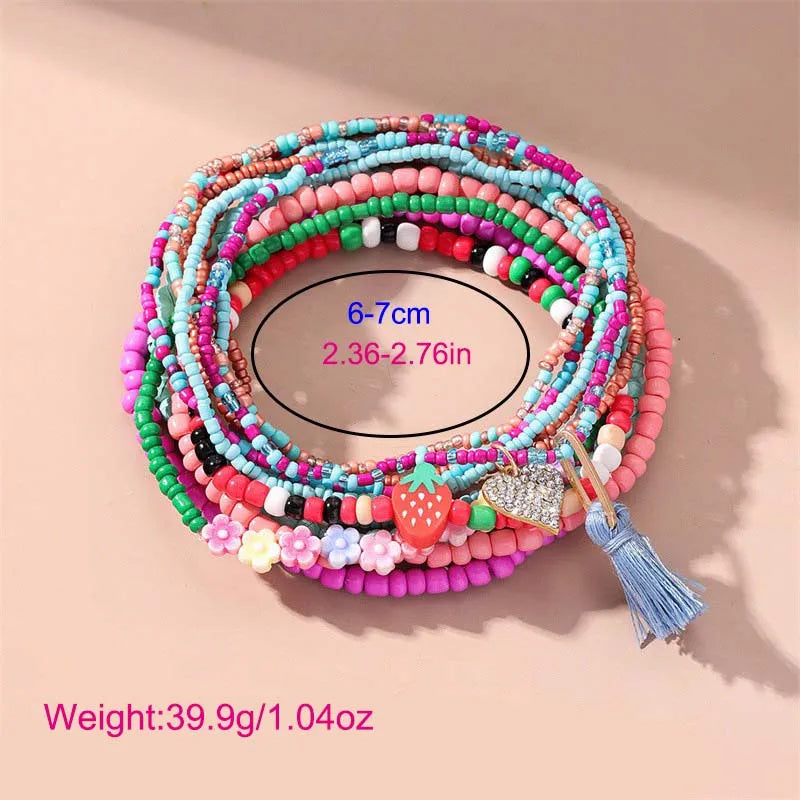 This anklet set features a Y2K style ankle bracelet set designed for women to wear during the summer at the beach. The anklets are hand-woven and adorned with colorful beads for a trendy look.