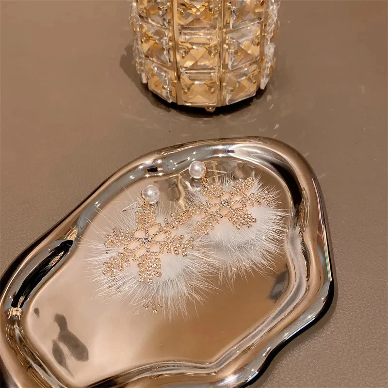 Experience the latest Christmas fashion with our exquisite 2023 collection of earrings. These elegant earrings feature a combination of zircon, pearls, and snowflake designs, adding a touch of sophistication and charm to your look. Perfect for those who appreciate a princess-like style, these earrings are sure to make a statement.