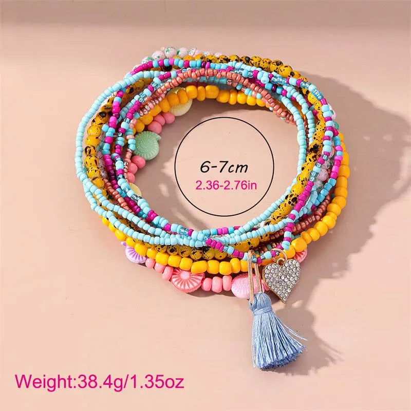 This anklet set features a Y2K style ankle bracelet set designed for women to wear during the summer at the beach. The anklets are hand-woven and adorned with colorful beads for a trendy look.