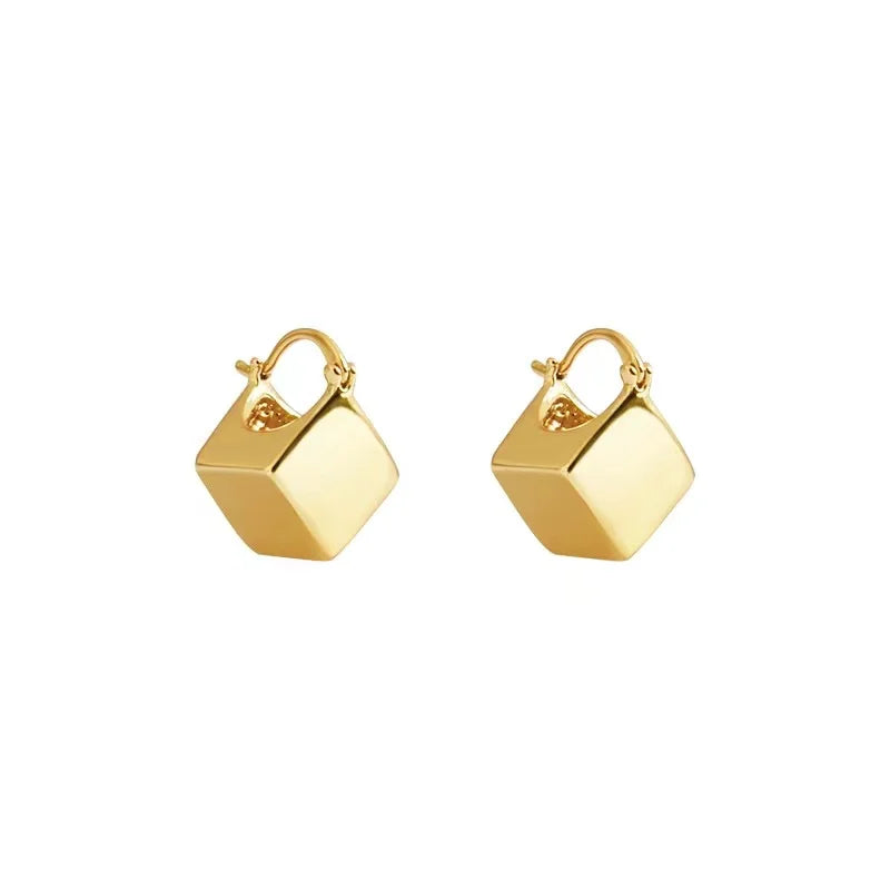 Elevate your fashion game with these exquisite gold-colored pendant earrings. Designed in a simple cubic shape, these accessories are perfect for women who want to make a statement at weddings or parties. Whether you're in Europe or America, these earrings will add a touch of elegance to your fashion style.