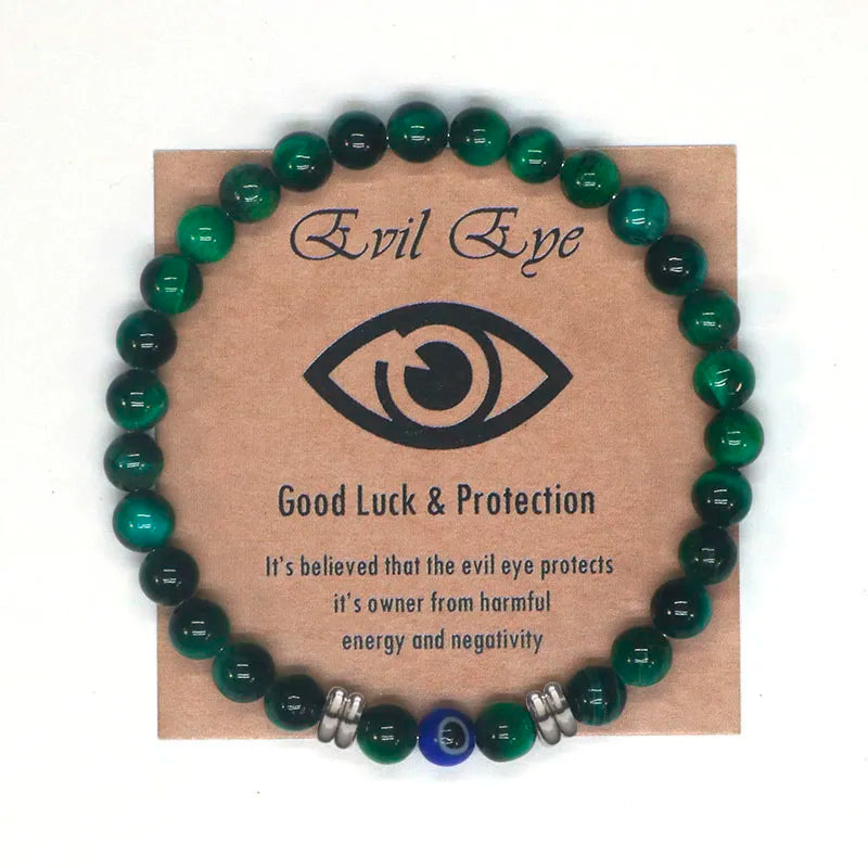 The captivating Tiger Eye Beaded Bracelet, a unisex Turkish Amulet that offers protection against the evil eye. This exquisite piece of spiritual jewelry is designed for both men and women, featuring natural Tiger Eye beads and a striking blue Evil Eye charm.