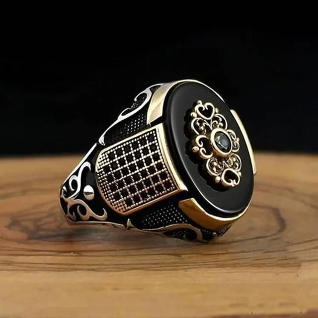 The epitome of elegance with this exquisite men's ring. Crafted from high-quality metal, it features a captivating gold color and is adorned with a striking black stone and zircon accents. Perfect for engagements, weddings, or simply adding a touch of luxury to your everyday style, this punk-inspired ring is a must-have in any fashion-forward man's collection.