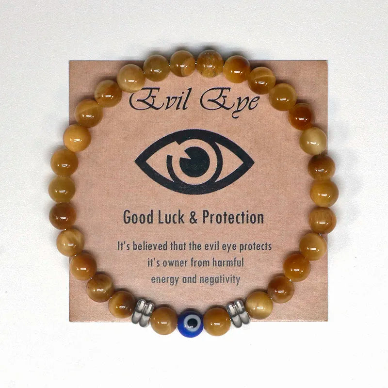 The captivating Tiger Eye Beaded Bracelet, a unisex Turkish Amulet that offers protection against the evil eye. This exquisite piece of spiritual jewelry is designed for both men and women, featuring natural Tiger Eye beads and a striking blue Evil Eye charm.